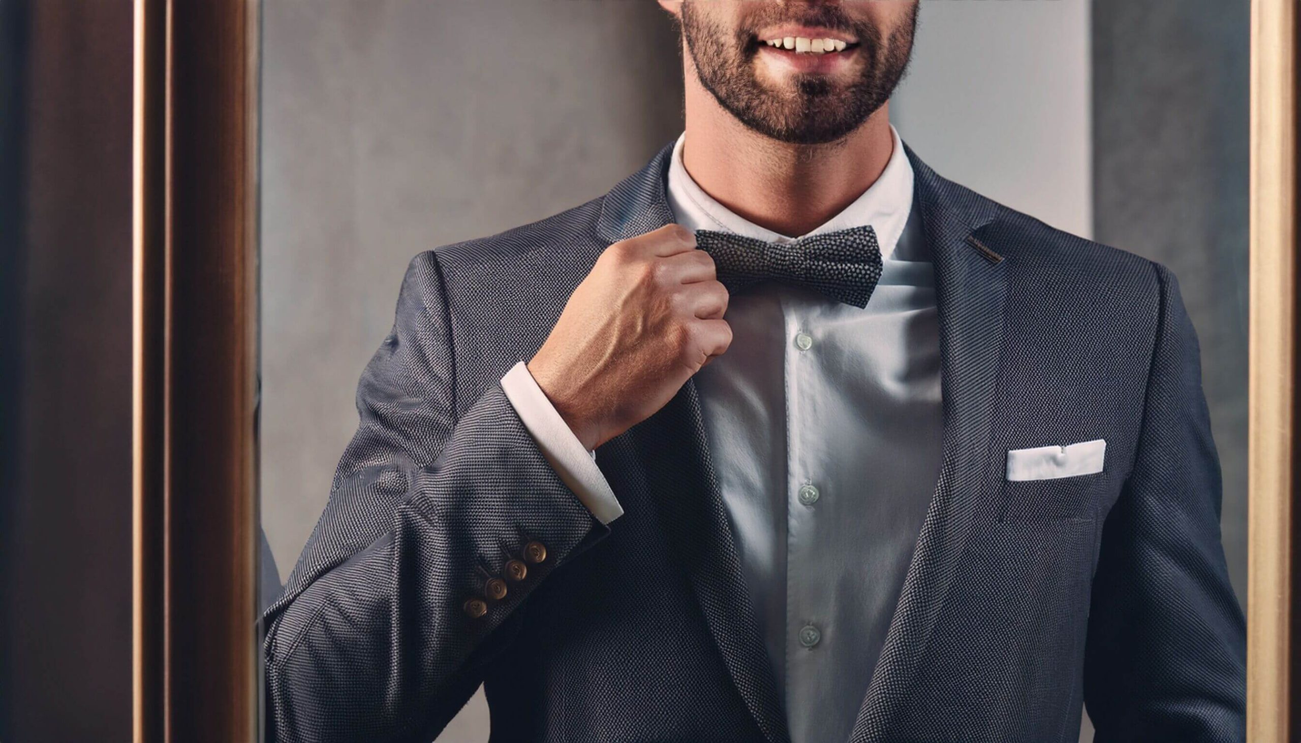 gentleman checking his suit in a mirror